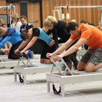 Men doing Pilates on reformers