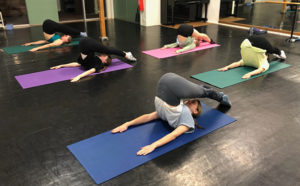 Young ballet dancers doing Pilates - Rollover